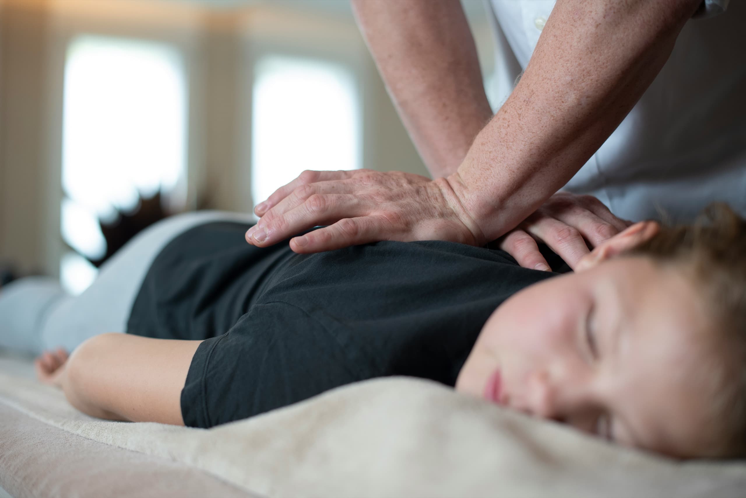Chiropractor performing a spinal adjustment at Summit Spine Centre in Airdrie