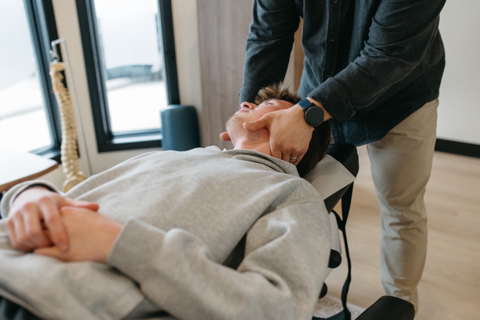 Chiropractor performing a spinal adjustment at Summit Spine Centre in Airdrie